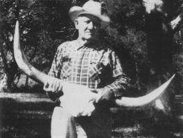 This photograph of Milby Butler also shows one of his prize Longhorn skulls.